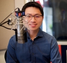 portrait of Hansi Lo Wang ’09 in front of a radio microphone